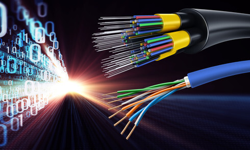 A visual side-by-side comparison featuring a thick bundle of blue Cat6 copper cables next to a slim strand of yellow single-mode fiber, illustrating the physical and bandwidth differences between the two media.