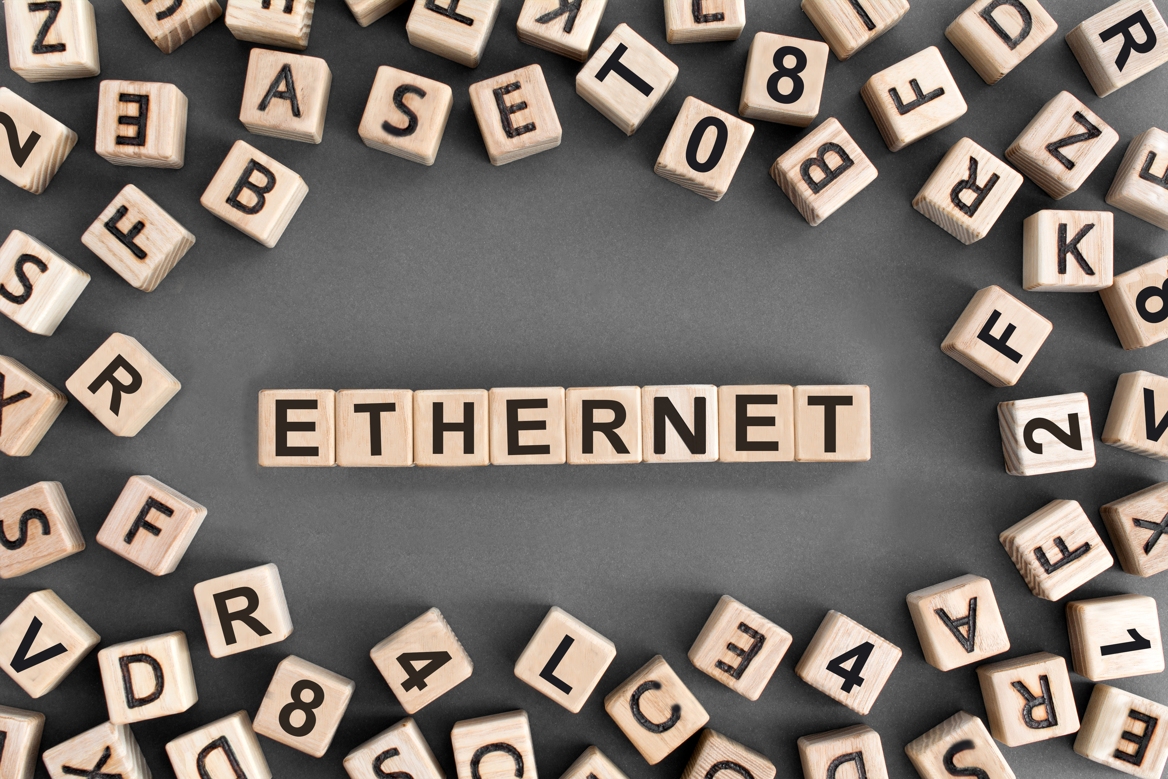 Image featuring various alphanumeric tiles associated with Ethernet standards, with central letter tiles explicitly spelling out "ETHERNET."