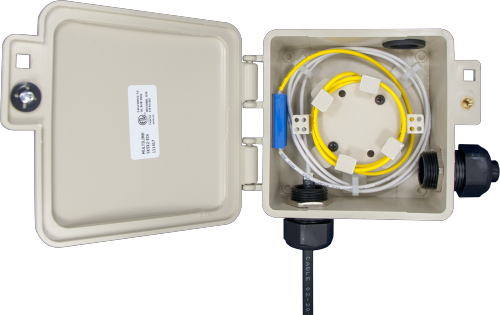 Fiber optic wall-mount enclosure with coiled cable and internal cable management maintaining proper bend radius