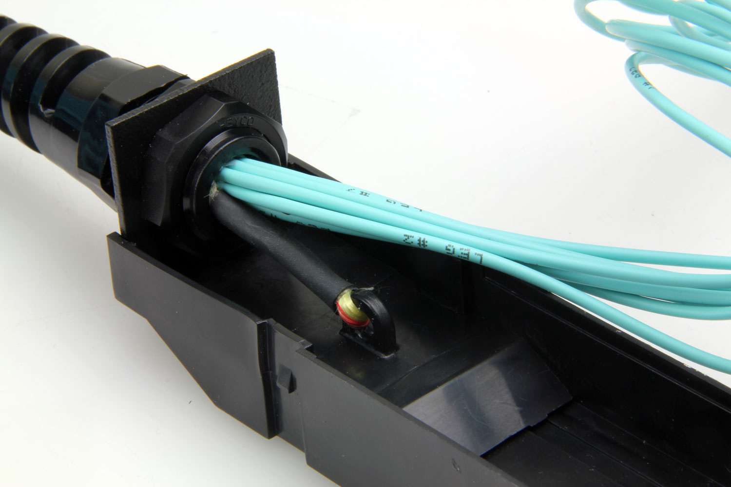 Image of the inside of an HD8² HDReadyLink Cassette showing how the internal strength members are attached to the strain relief to prevent tension on the fiber.