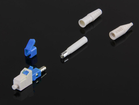A clean, studio shot of several LC duplex fiber optic connectors in various colors (blue, green, and beige) with their ceramic ferrules exposed, showcasing the standard interface for modern fiber networking.